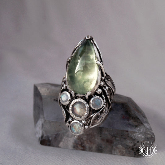 One-of-a-kind sterling silver ring with pear-shaped prehnite and moonstones in vertical sculptural setting