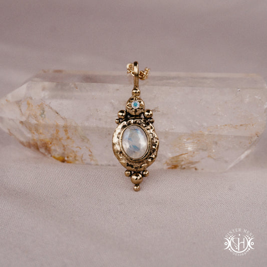 Handmade organic pendant with moonstone and compact ancient-inspired form. Made to order in brass, silver or gold.