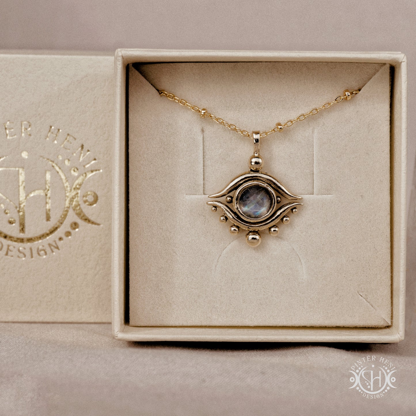 Hand-carved eye pendant in brass from the Primal Symbols collection by Pintér Heni Design, in jewelry box