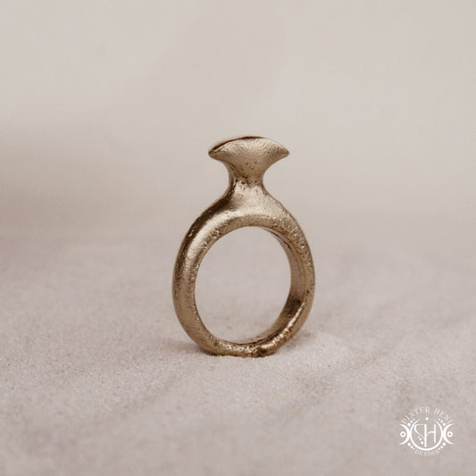 Glyph Ring handmade sandcast brass ring with curved sculptural top and ancient symbolic character