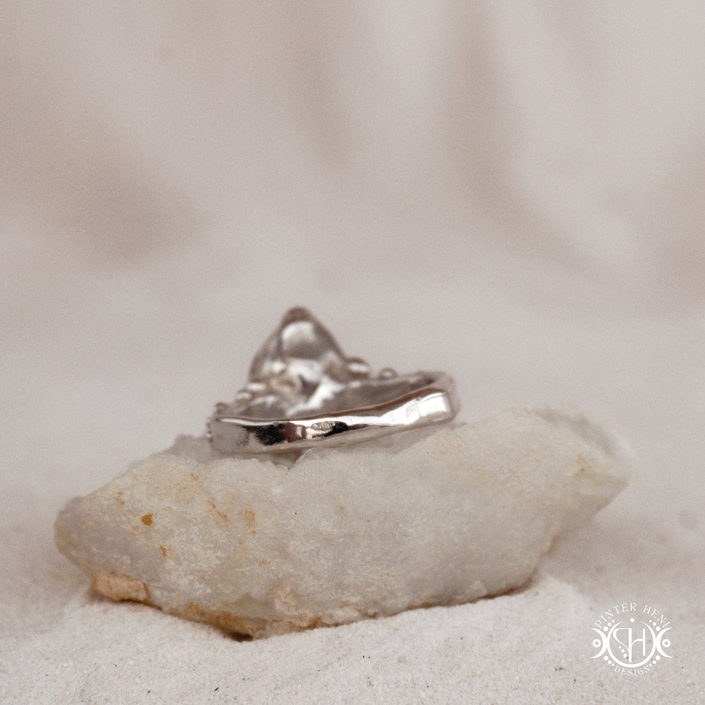 Silver ring on a white stone with a blurred background
