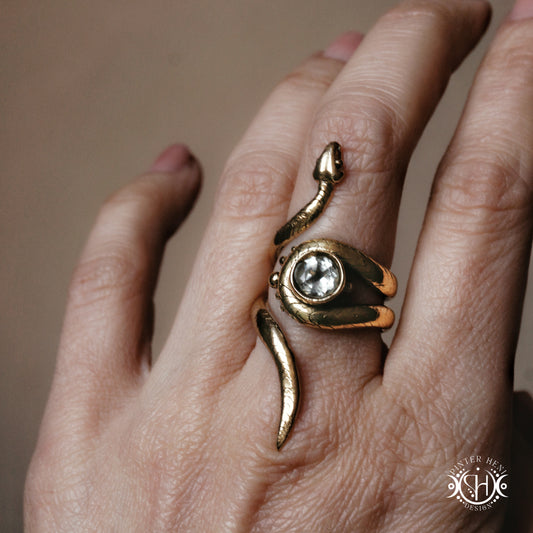 Handmade adjustable serpent ring set with prasiolite, sculptural wax carved design in brass, worn on hand.