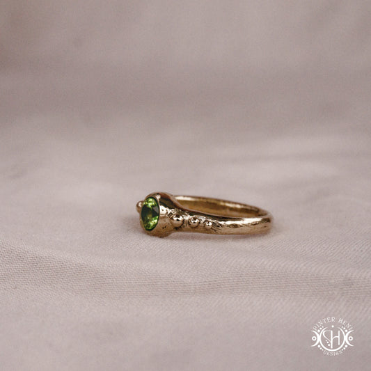 Star Cluster Ring with peridot and surrounding bead details in handcrafted metal