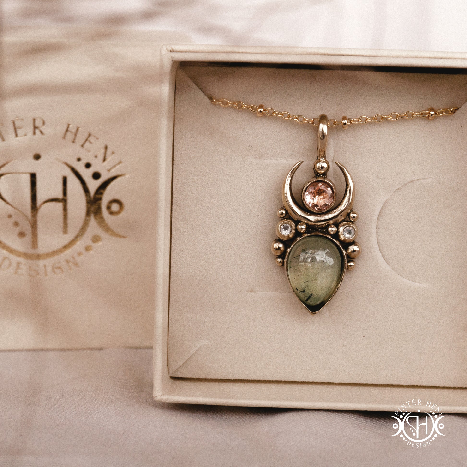 Handmade Artemis pendant with green prehnite and morganite in brass setting, in a branded jewelry box. Available in brass, silver, and solid gold.
