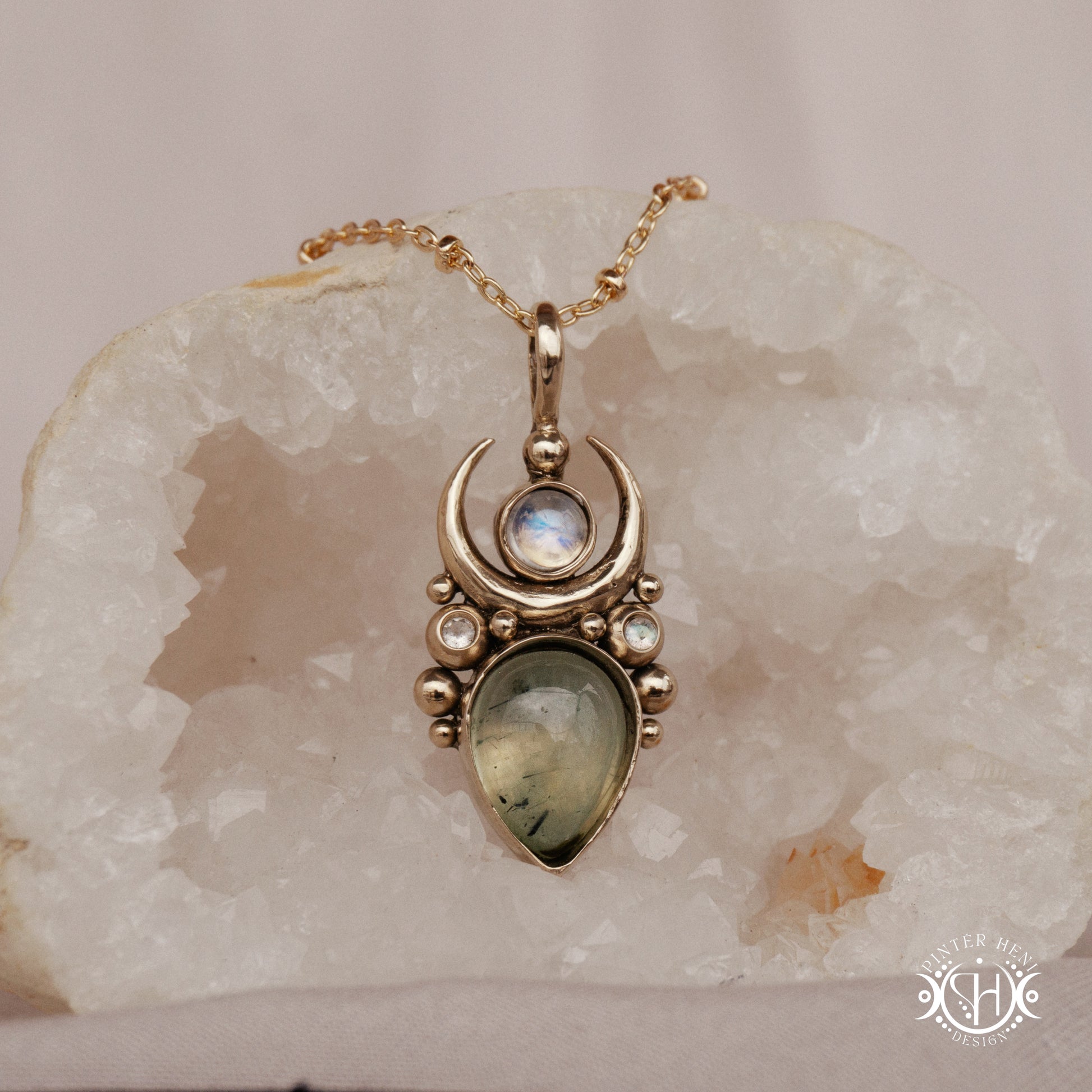 Brass Moon pendant with prehnite and moonstone, on crystal