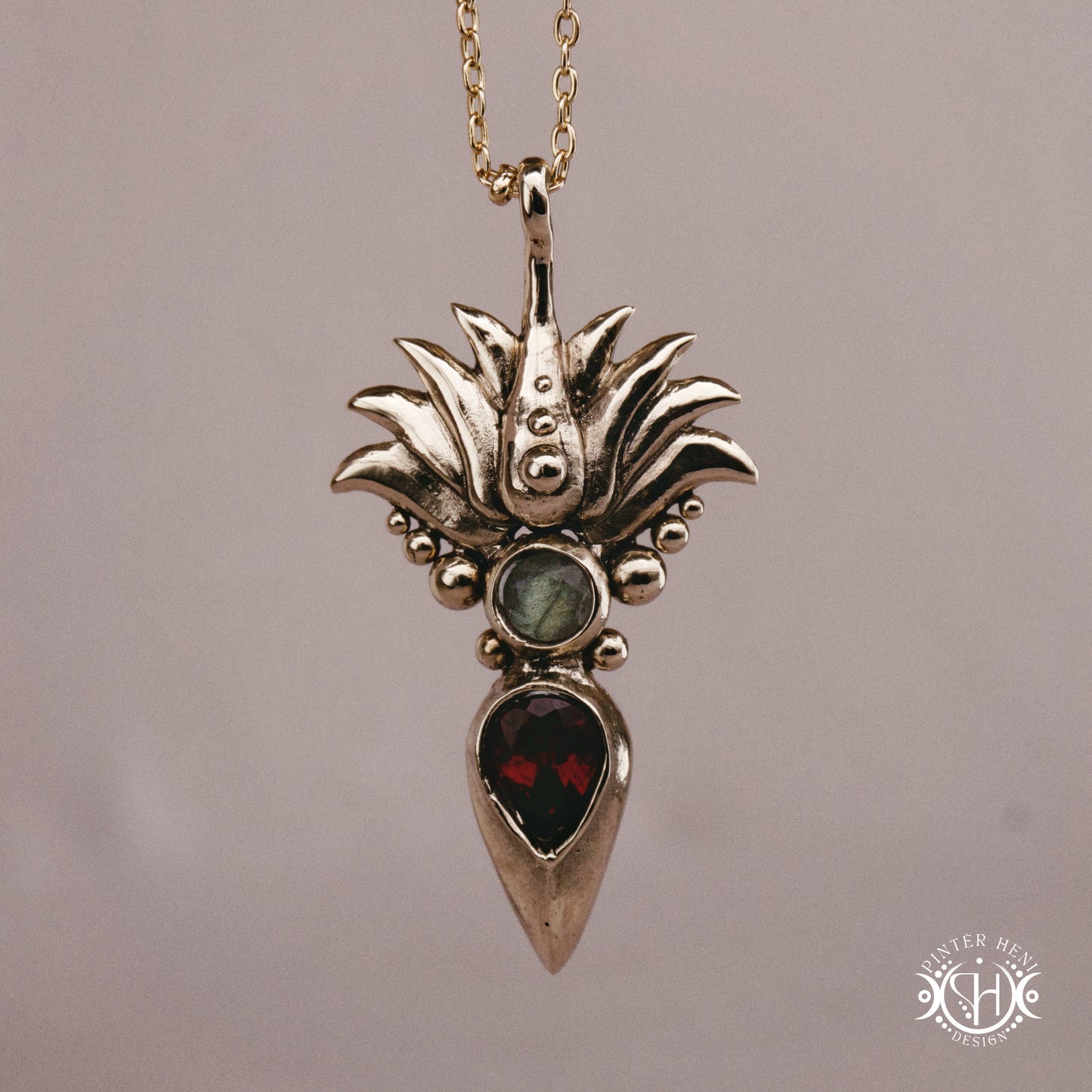 Handmade Agave pendant with garnet stone, sculptural desert-inspired botanical necklace.