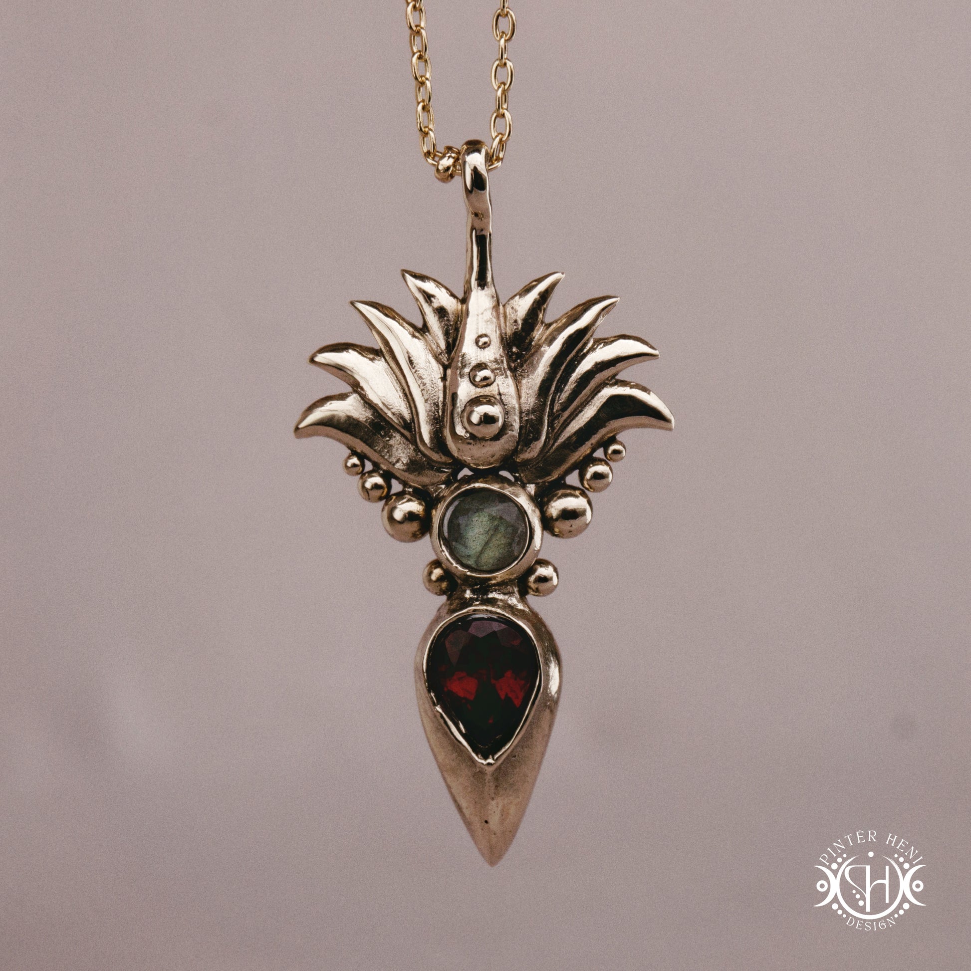 Handmade Agave pendant with garnet stone, sculptural desert-inspired botanical necklace.