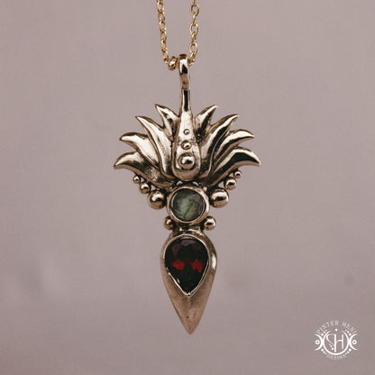 Handmade Agave pendant with garnet stone, sculptural desert-inspired botanical necklace.