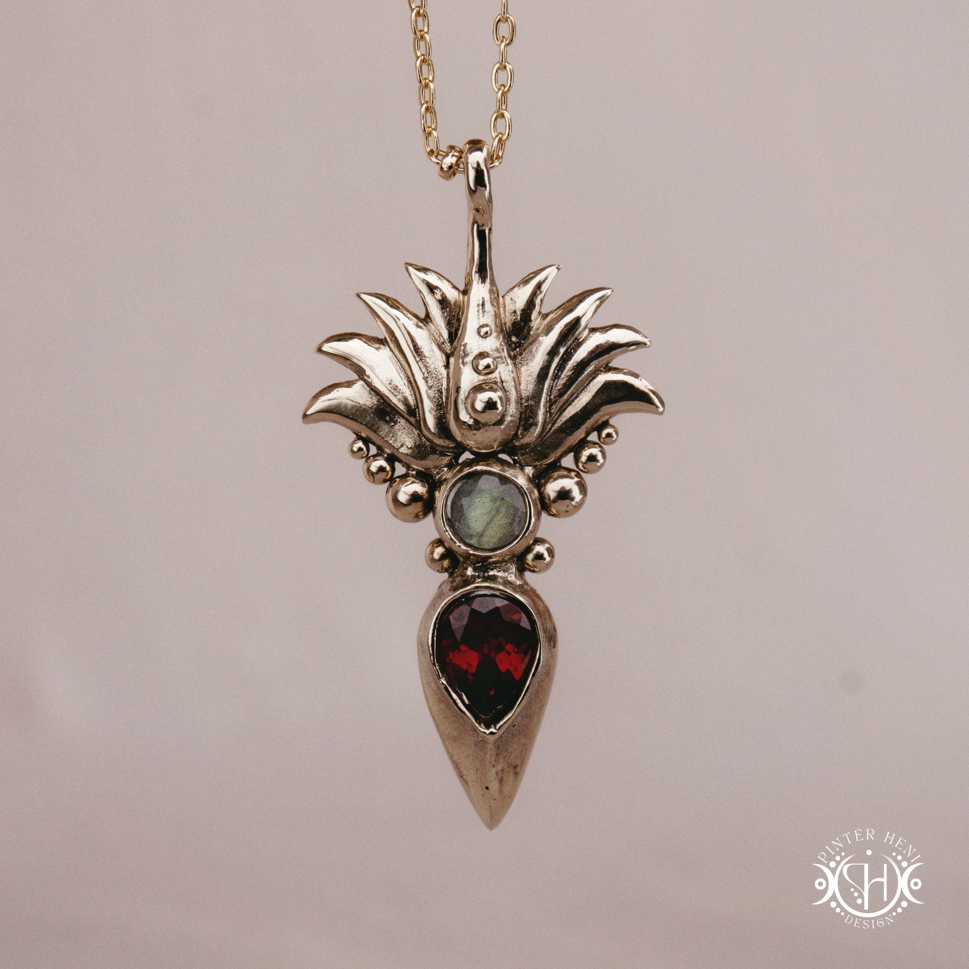 Handmade Agave pendant with garnet stone, sculptural desert-inspired botanical necklace.