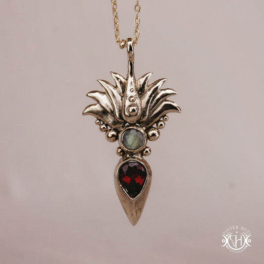 Handmade Agave pendant with garnet stone, sculptural desert-inspired botanical necklace.