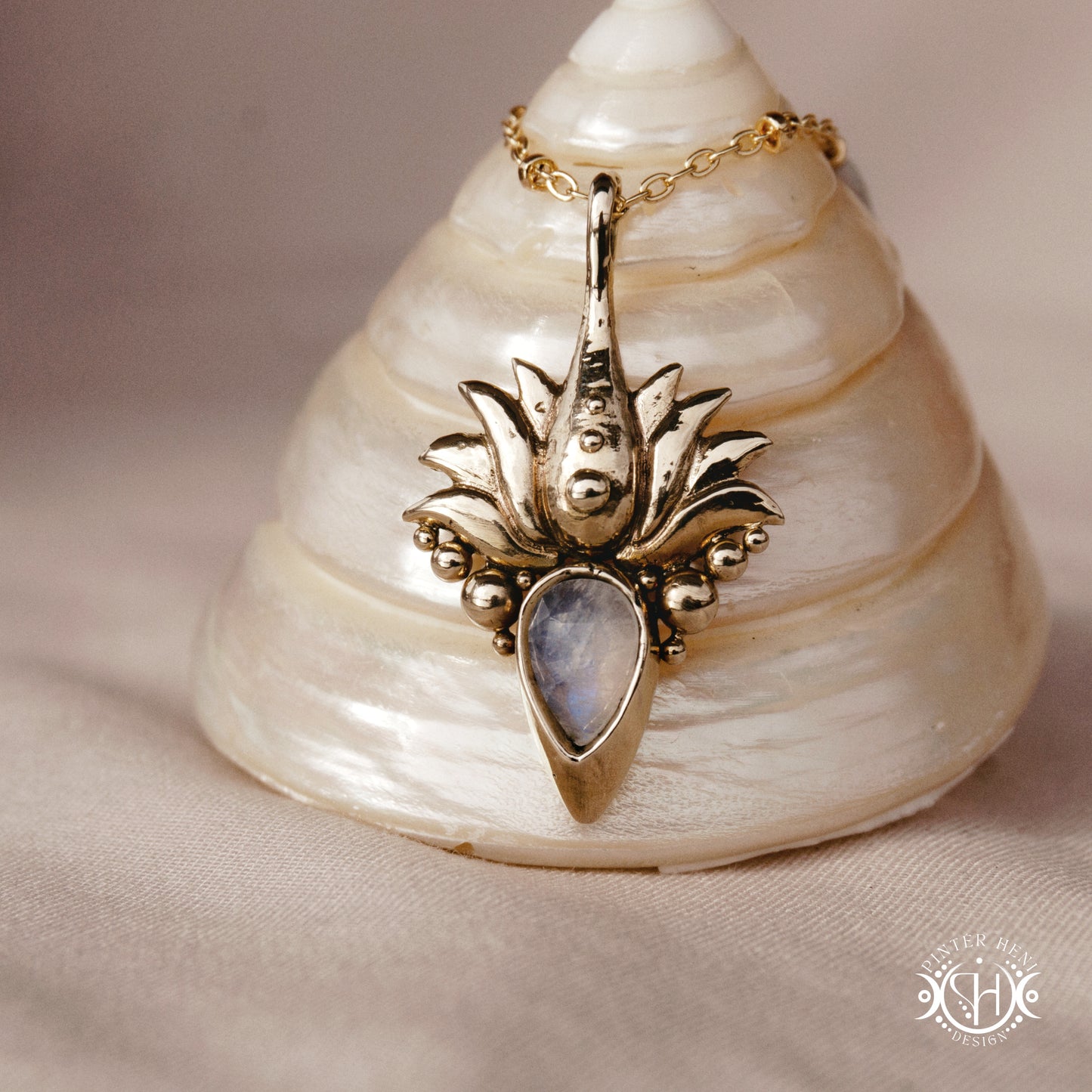 Hand-carved Agave pendant inspired by desert plant structure, sculptural botanical necklace in brass, on a shell