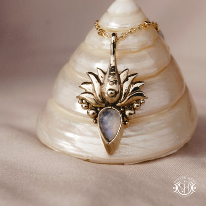 Hand-carved Agave pendant inspired by desert plant structure, sculptural botanical necklace in brass, on a shell