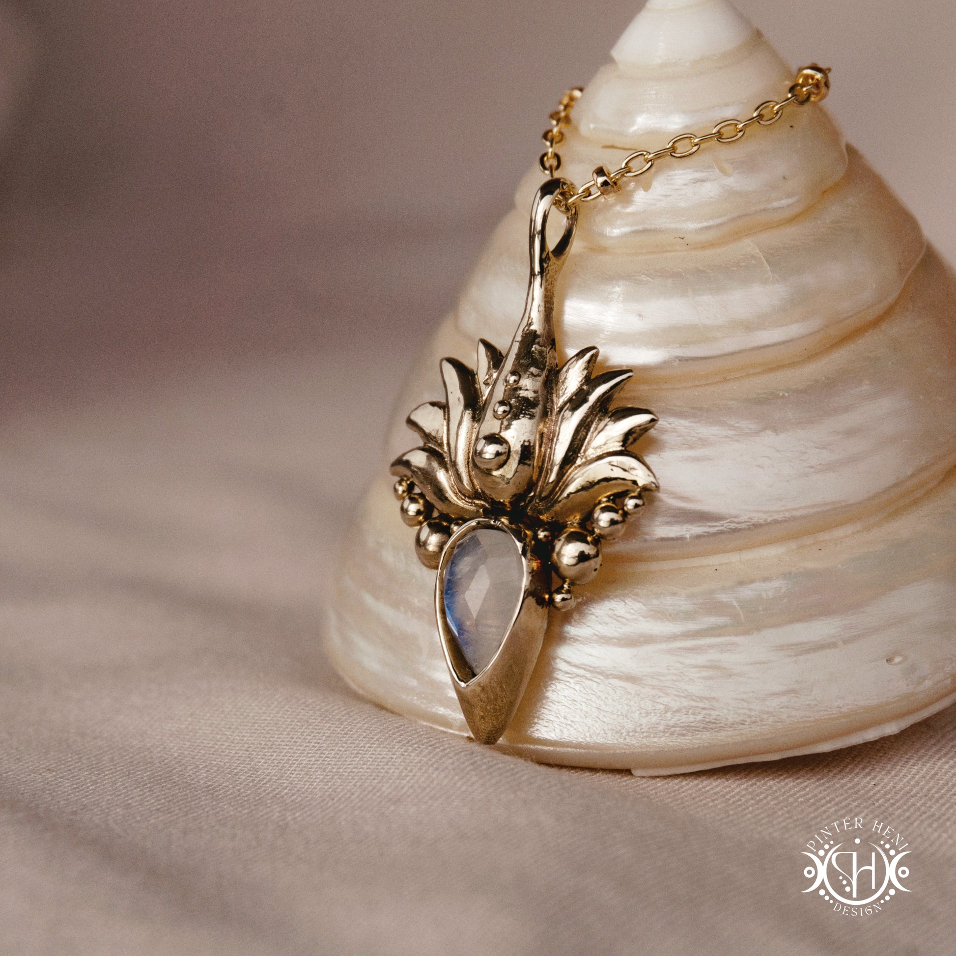 Hand-carved Agave pendant inspired by desert plant structure, sculptural botanical necklace in brass, on a shell