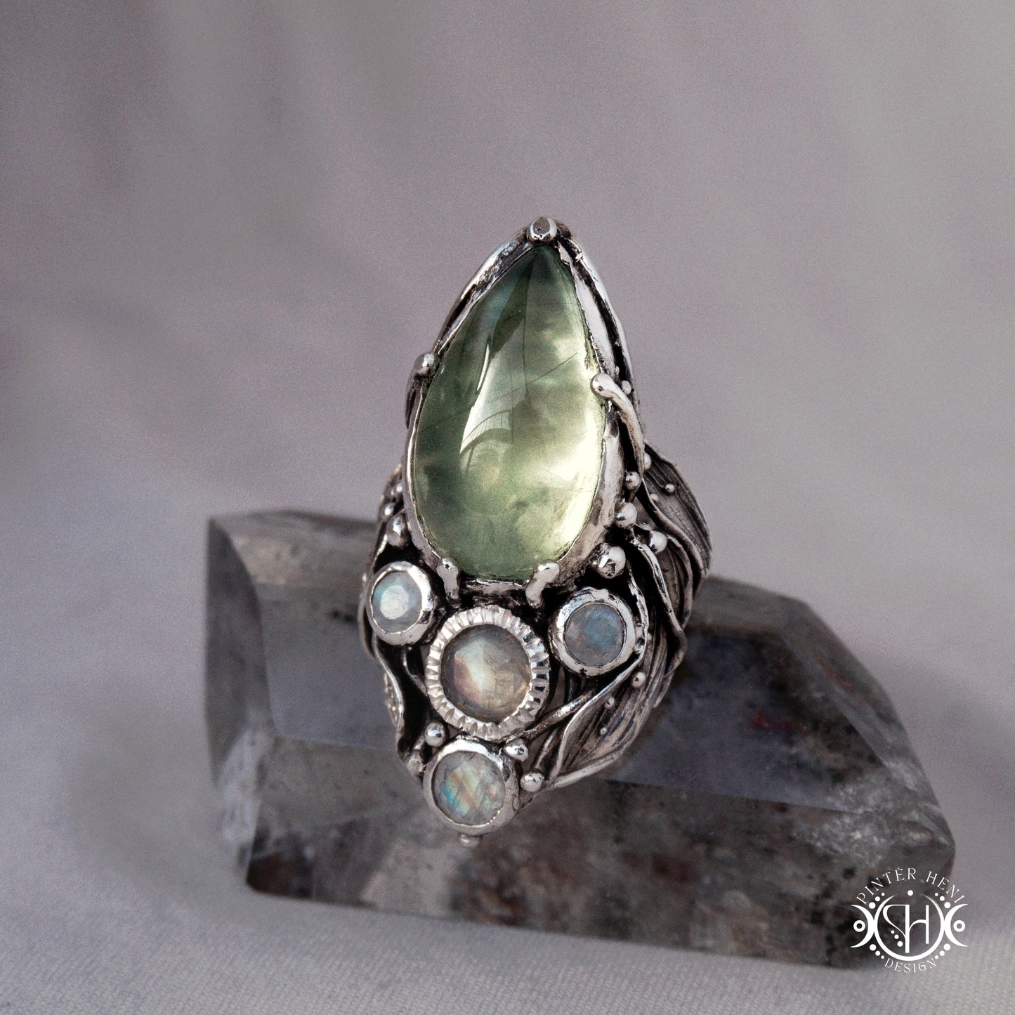 One-of-a-kind sterling silver ring with pear-shaped prehnite and moonstones in vertical sculptural setting