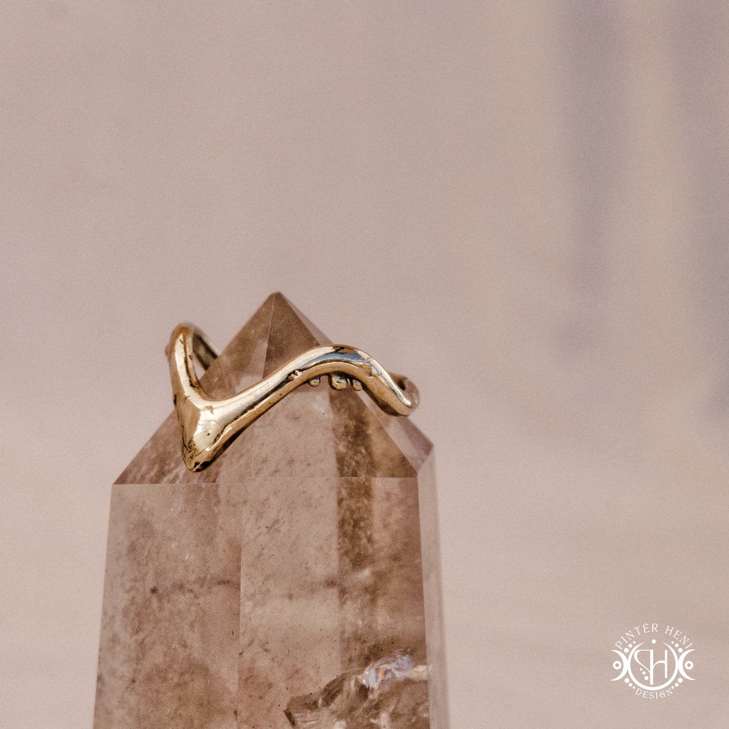 Arc Ring organic sculptural wave ring handmade in brass with rounded nodular details, on crystal.