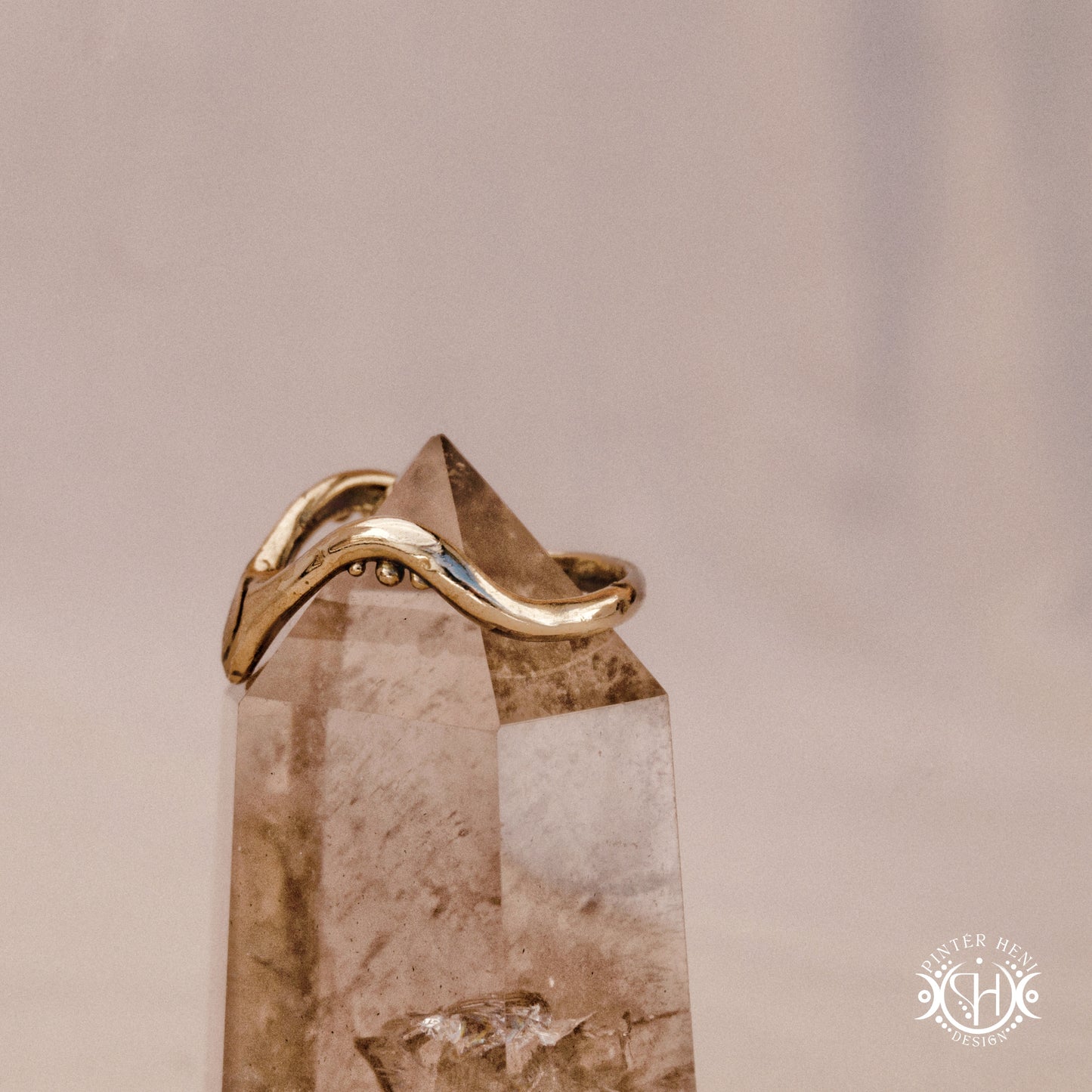 Arc Ring organic sculptural wave ring handmade in brass with rounded nodular details, on crystal.