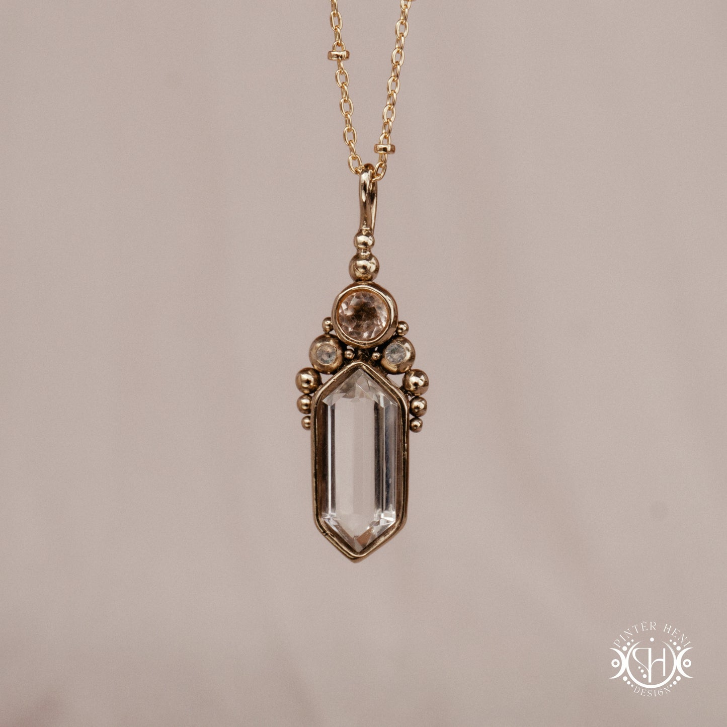 Handmade brass pendant with clear quartz and morganite, front view