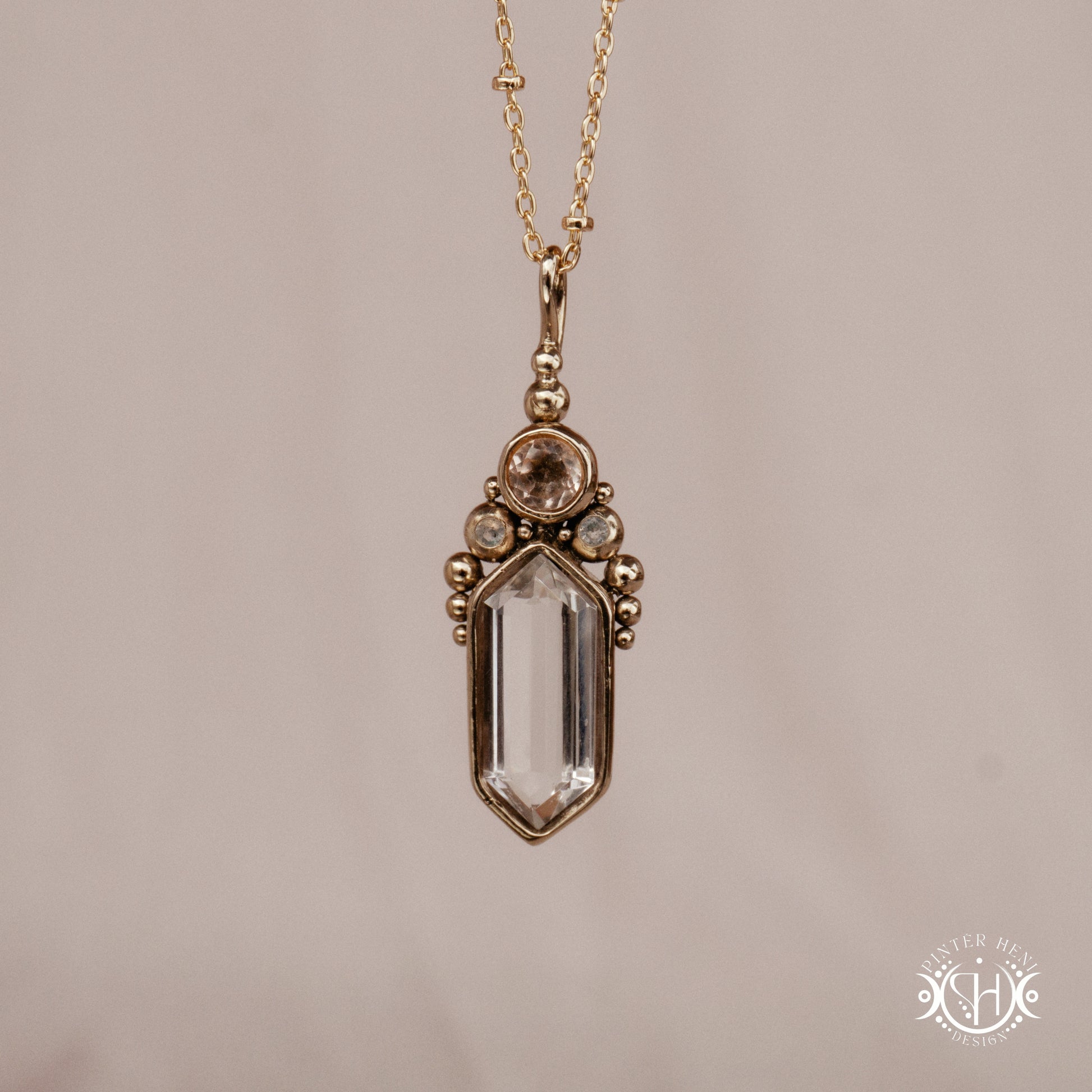 Handmade brass pendant with clear quartz and morganite, front view