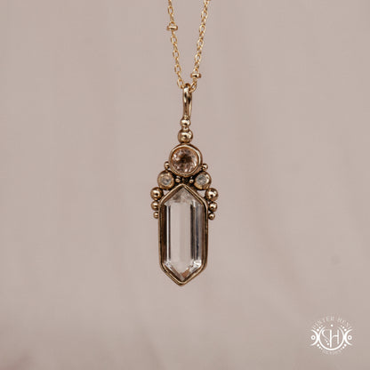 Handmade brass pendant with clear quartz and morganite, front view
