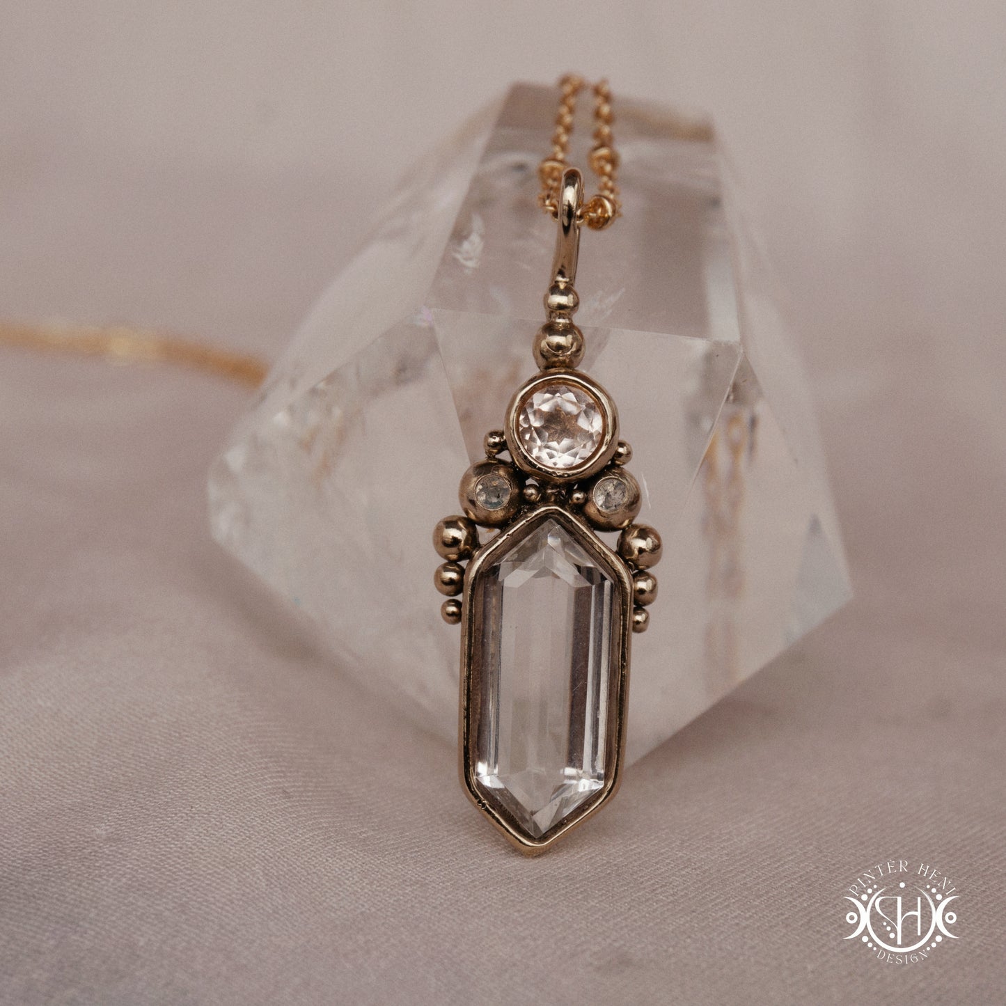 Handmade brass pendant with clear quartz and morganite, front view