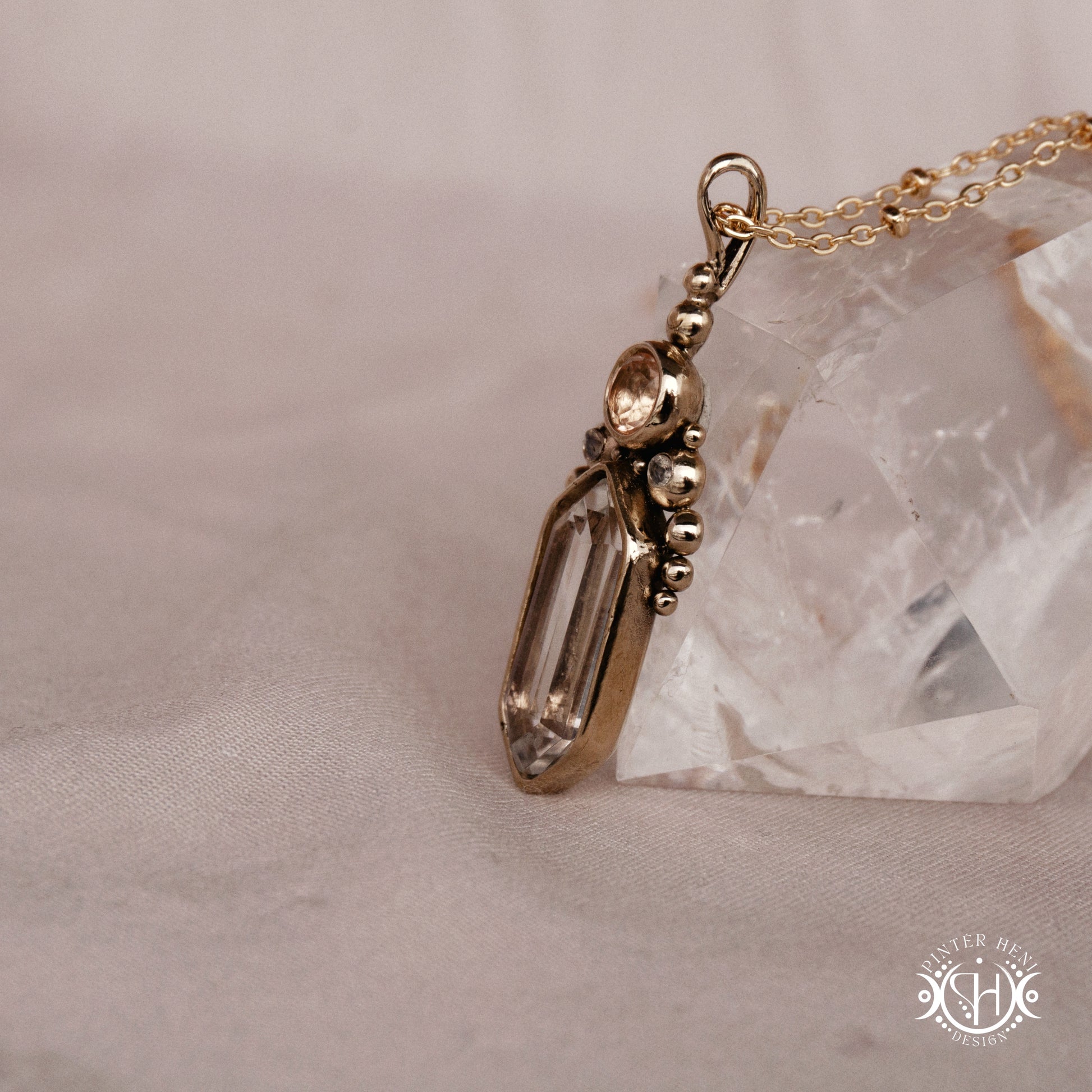 Handmade brass pendant with clear quartz and morganite, side view