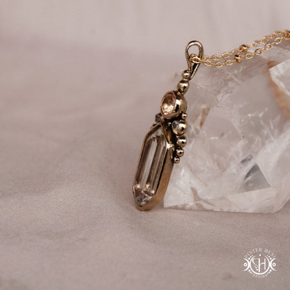 Handmade brass pendant with clear quartz and morganite, side view