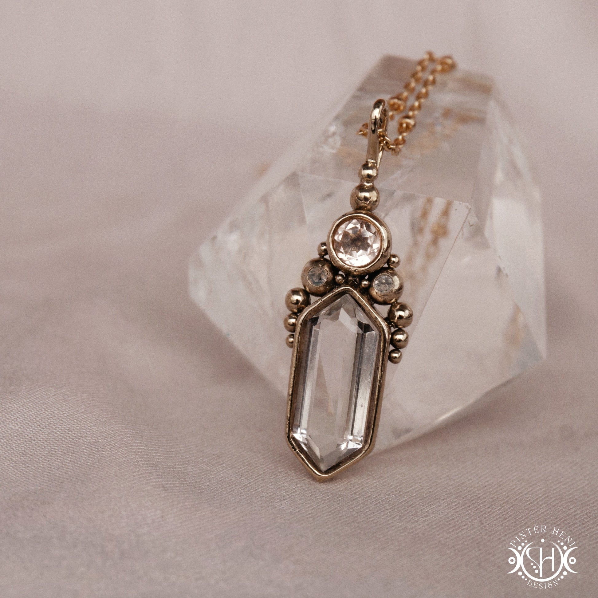 Handmade brass pendant with clear quartz and morganite, side view