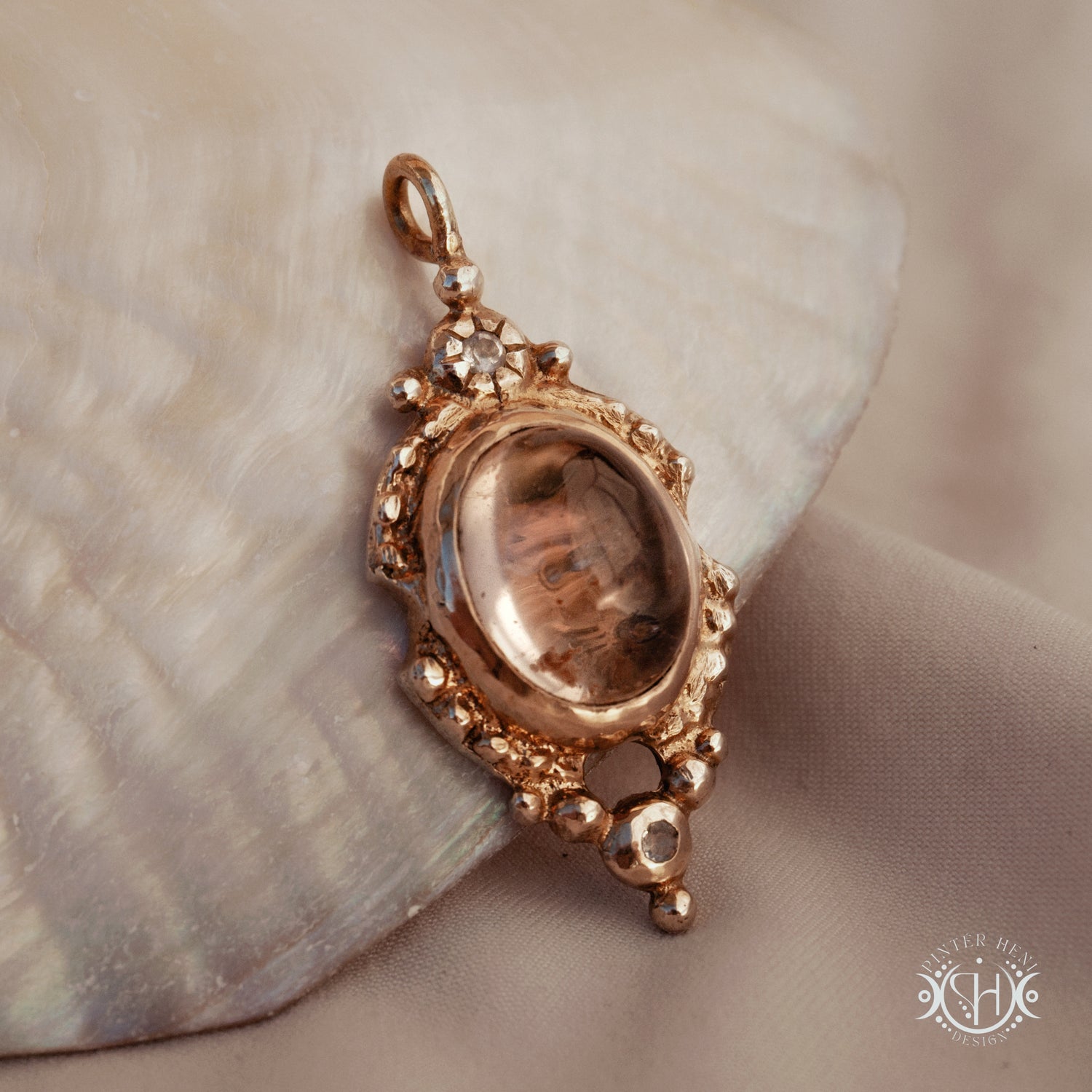 Hand-shaped brass pendant with lodolite quartz and moonstone, sculptural artisan necklace from the Asteria collection.