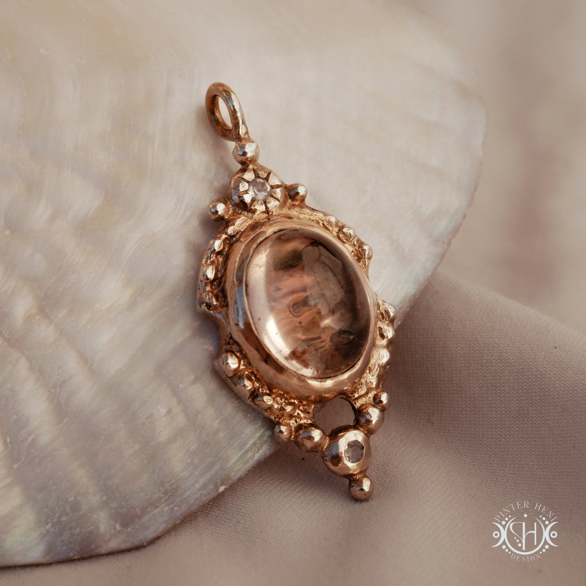 Hand-shaped brass pendant with lodolite quartz and moonstone, sculptural artisan necklace from the Asteria collection.
