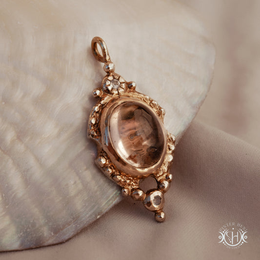 Hand-shaped brass pendant with lodolite quartz and moonstone, sculptural artisan necklace from the Asteria collection.