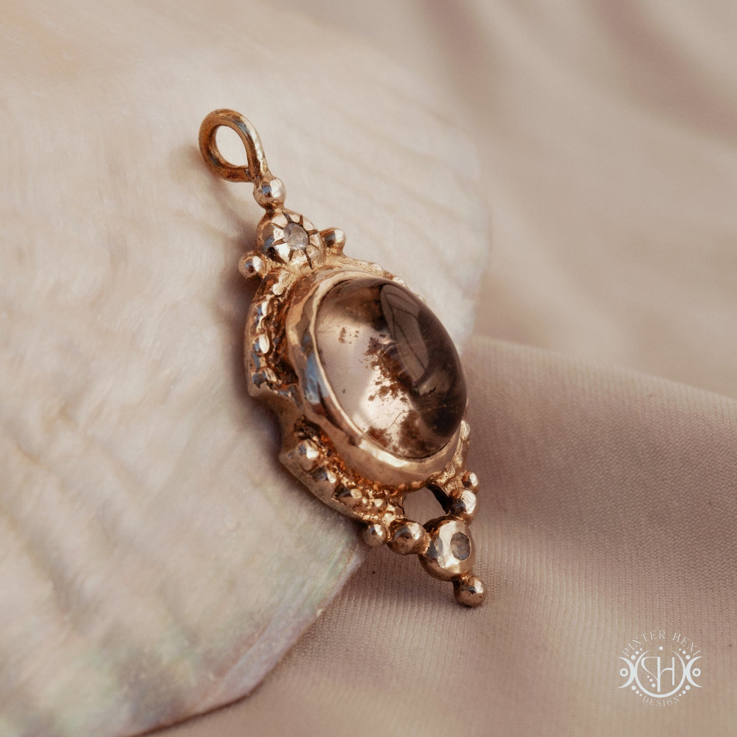 Hand-shaped brass pendant with lodolite quartz and moonstone, sculptural artisan necklace from the Asteria collection.