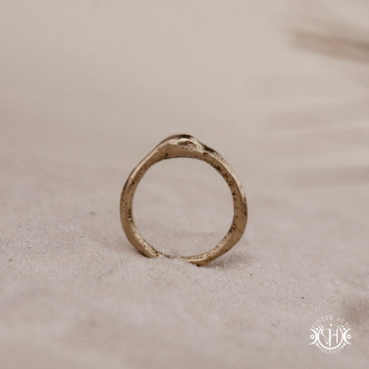 Cairn Ring handmade sandcast brass ring with clustered textured top, rustic ancient-inspired sculptural form, in sand.