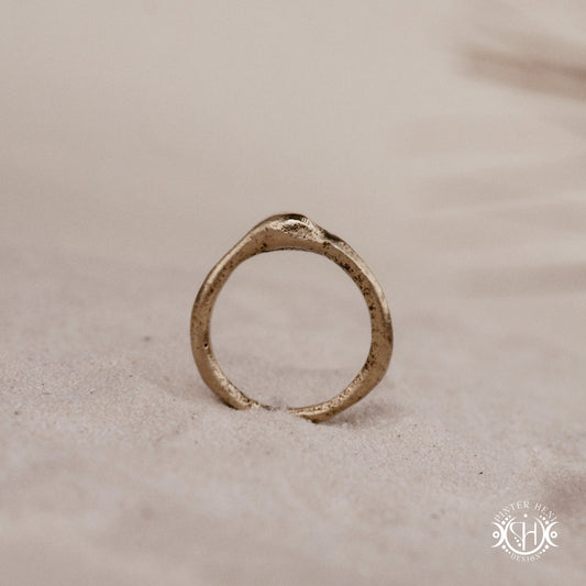Cairn Ring handmade sandcast brass ring with clustered textured top, rustic ancient-inspired sculptural form, in sand.