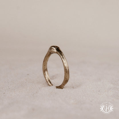 Cairn Ring handmade sandcast brass ring with clustered textured top, rustic ancient-inspired sculptural form, in sand.