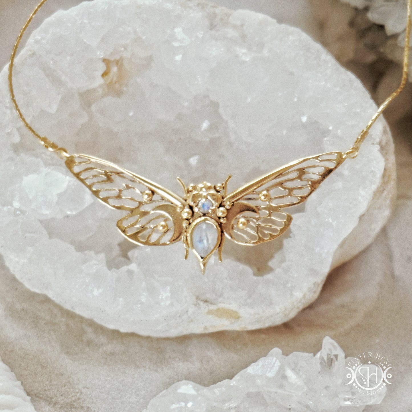 Handcrafted cicada pendant with moonstone in gold.