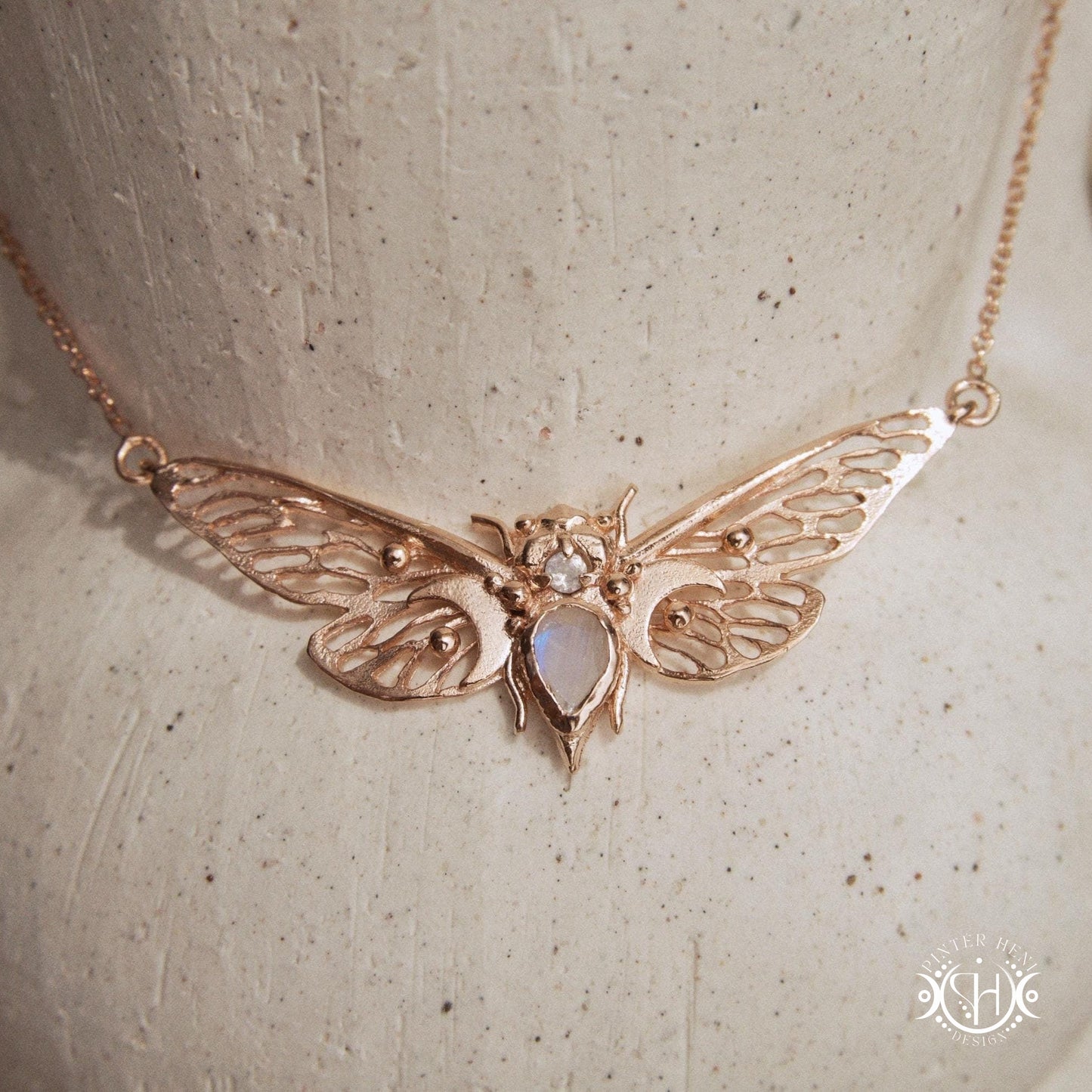 Handcrafted cicada pendant with moonstone in rose gold.