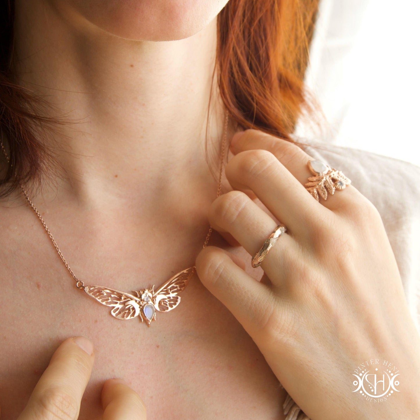 Handcrafted cicada pendant with moonstone in rose gold.