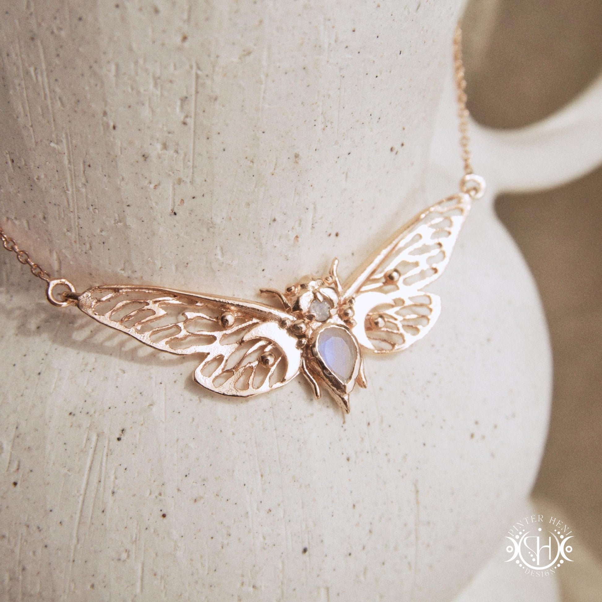 Handcrafted cicada pendant with moonstone in rose gold.