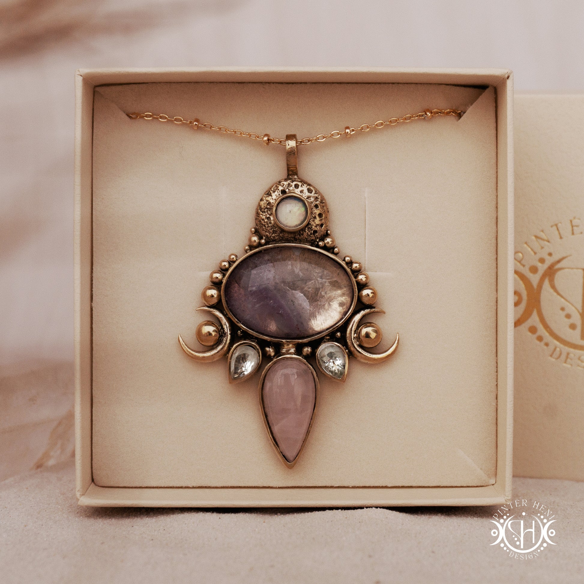 Hand-carved Demeter pendant with rose quartz, amethyst and prasiolite, in branded jewelry box.