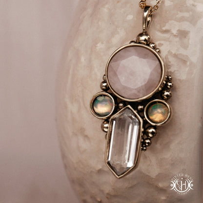 Brass pendant with rose quartz, clear quartz and opal stones, close view