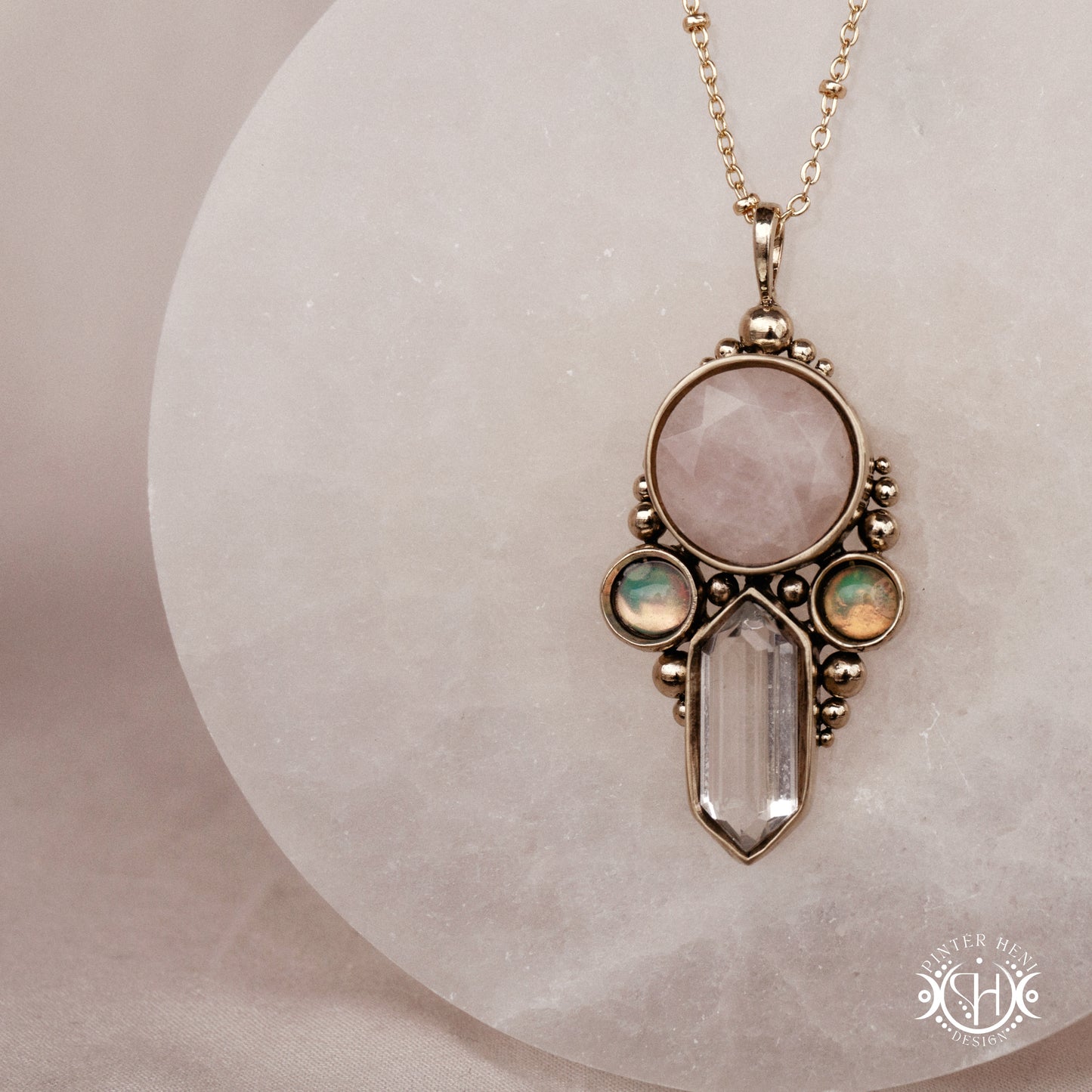 Brass pendant with rose quartz, clear quartz and opal stones, front view