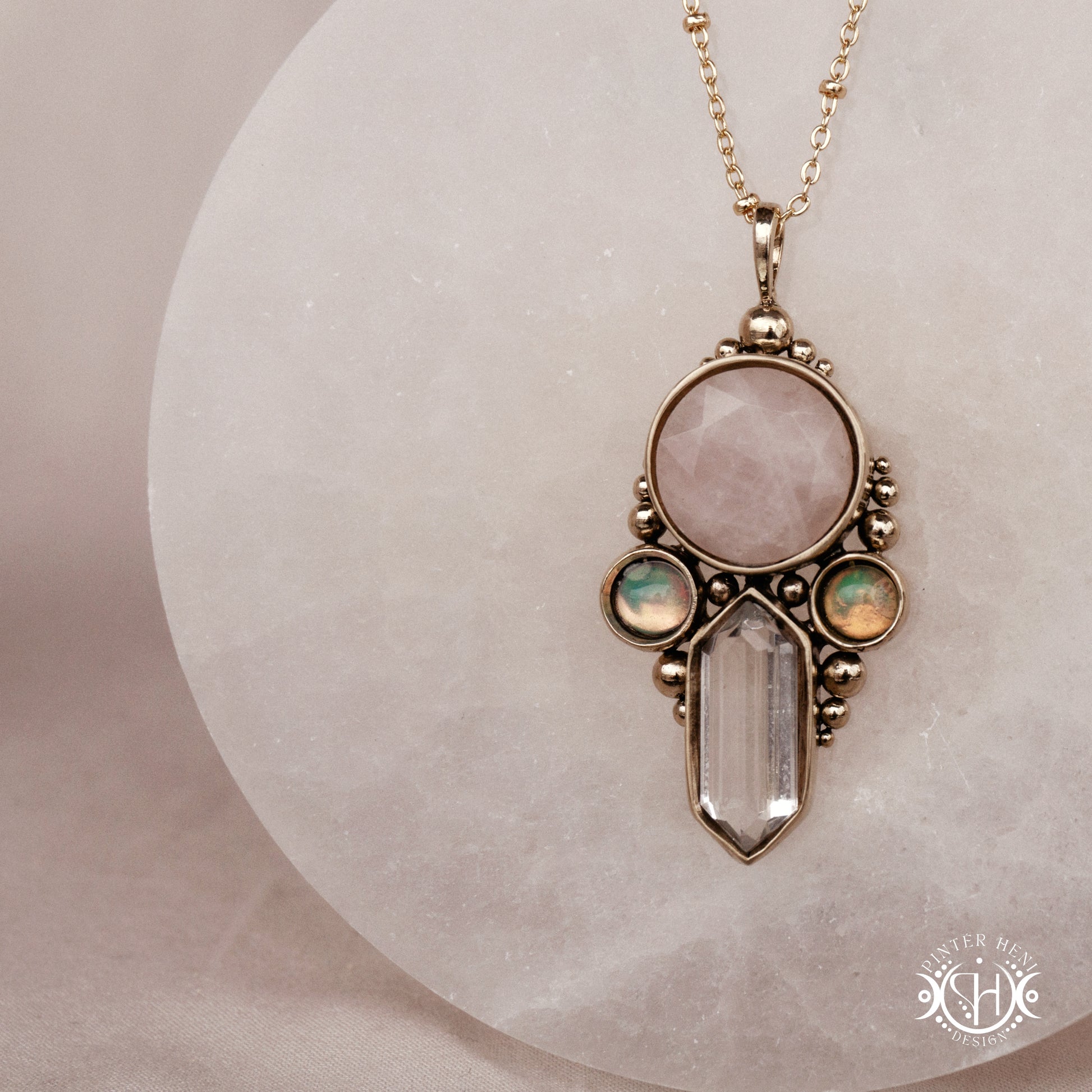 Brass pendant with rose quartz, clear quartz and opal stones, front view