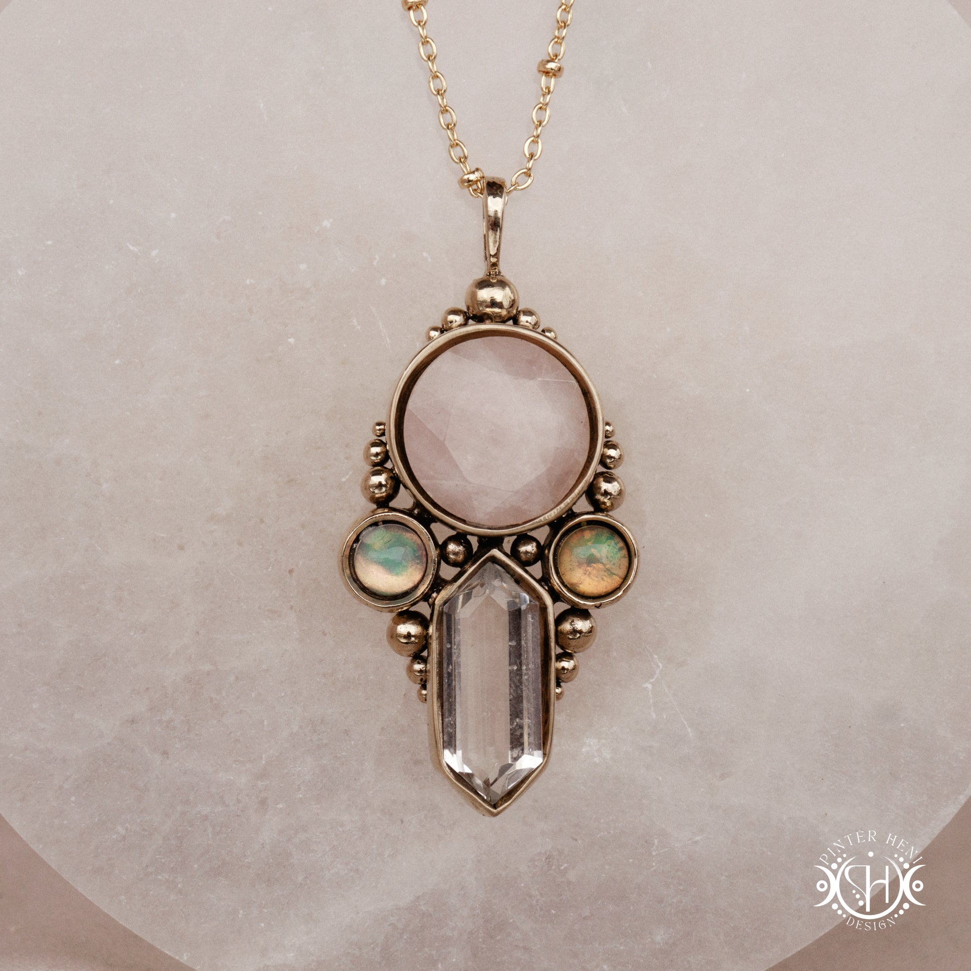 Brass pendant with rose quartz, clear quartz and opal stones, front view
