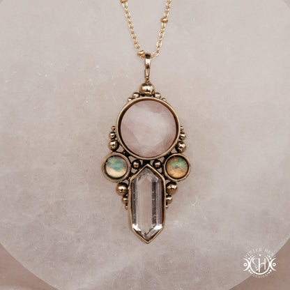 Brass pendant with rose quartz, clear quartz and opal stones, front view