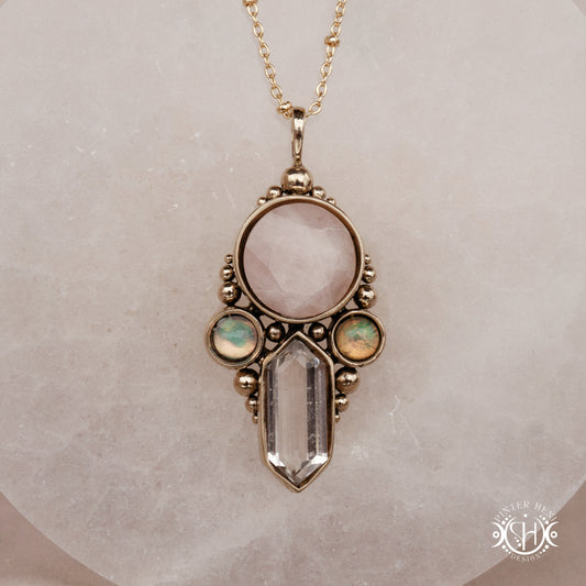 Brass pendant with rose quartz, clear quartz and opal stones, front view