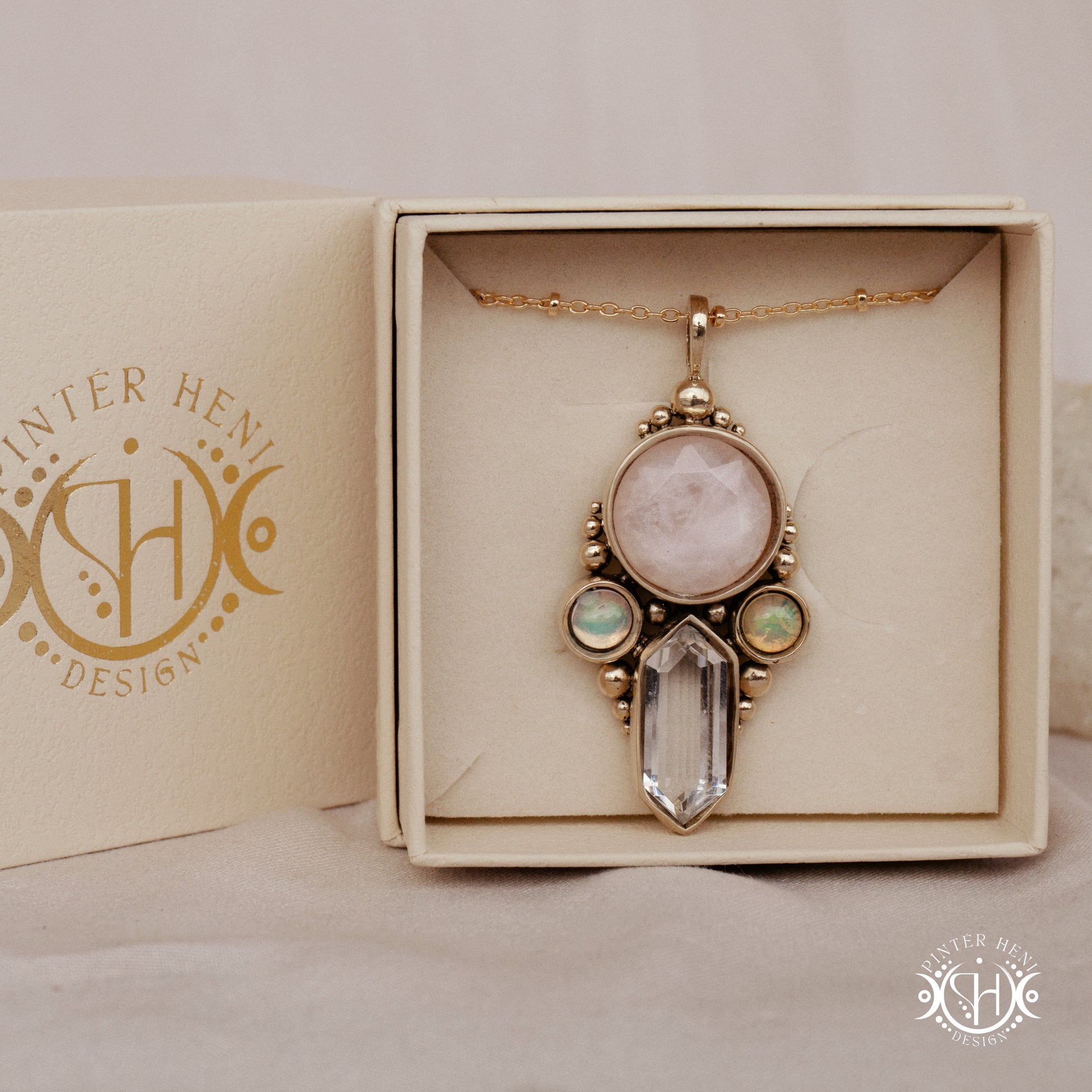 Brass pendant with rose quartz, clear quartz and opal stones, in branded jewelry box.