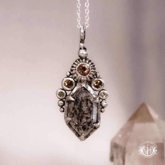 One of a kind sterling silver Desert Rites pendant with raw Herkimer diamond, tourmaline and green sapphire