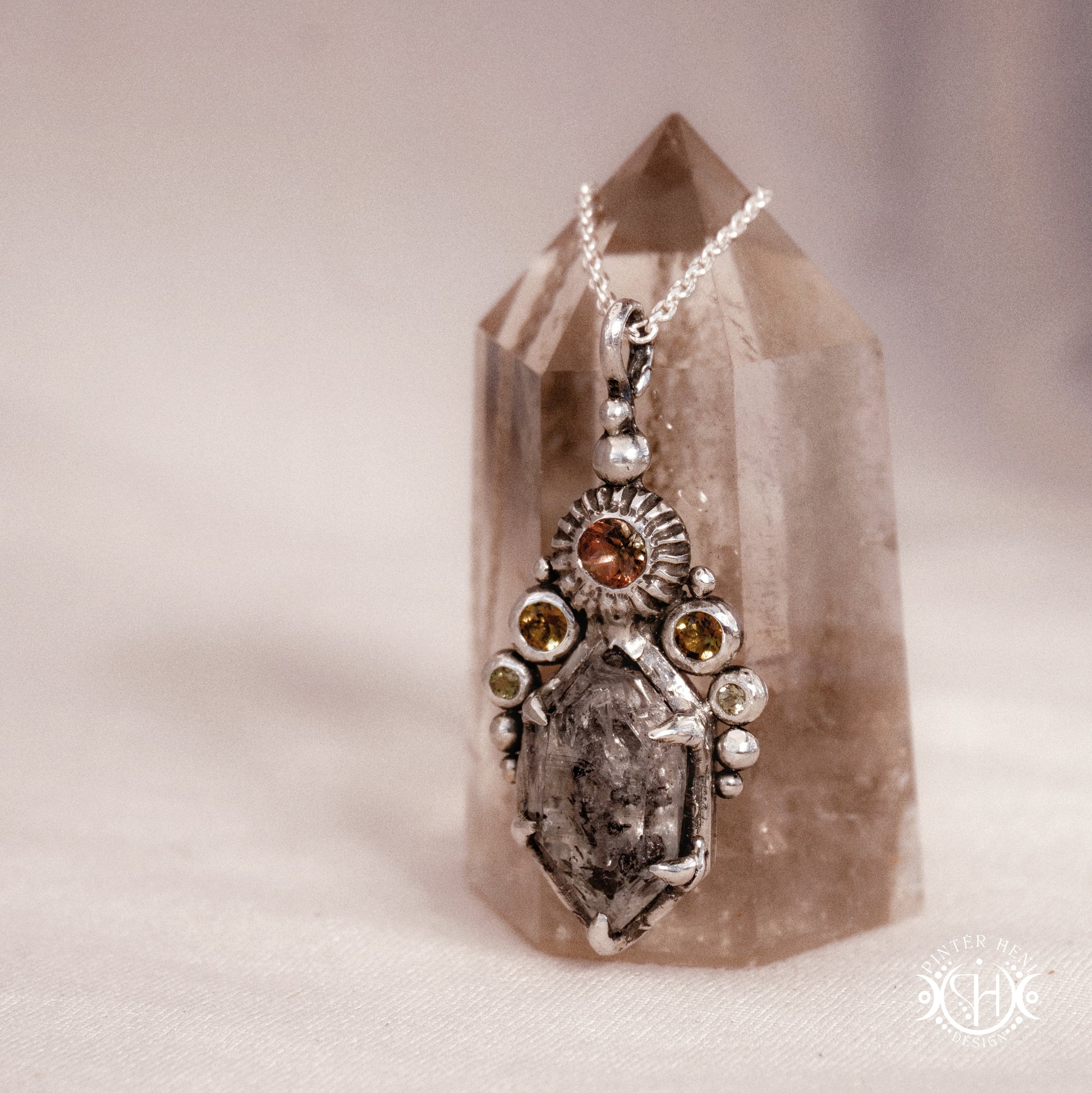 One of a kind sterling silver Desert Rites pendant with raw Herkimer diamond, tourmaline and green sapphire