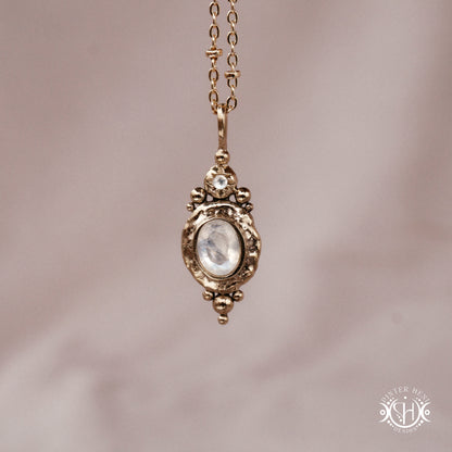 Handmade organic pendant with moonstone and compact ancient-inspired form. Made to order in brass, silver or gold.
