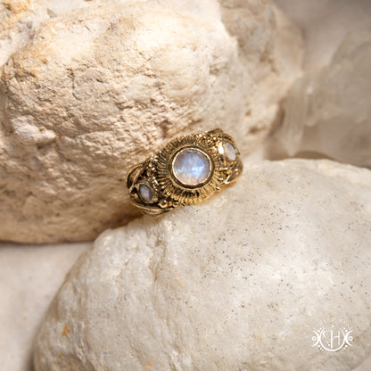 One-of-a-kind brass ring with three rainbow moonstones and sculptural carved band.